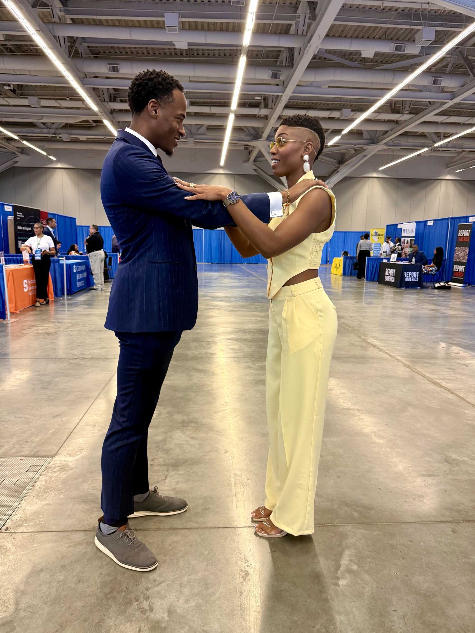 Stephon Dingle and Lena Pringle facing one another in conversation at a public event.